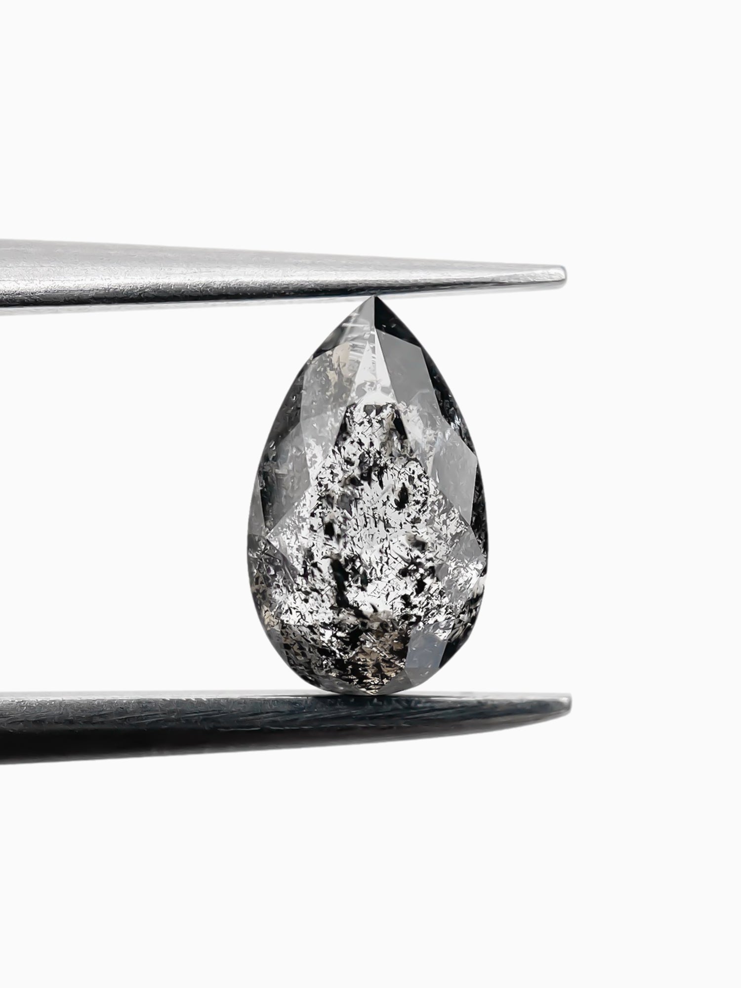 sustainable lab-grown pear shaped salt pepper diamond between tweezers