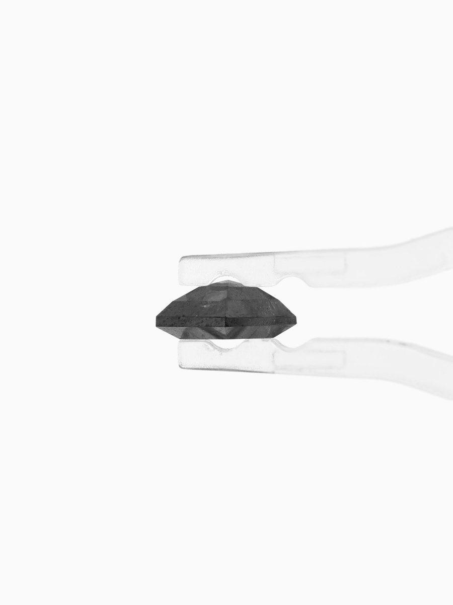side view of loose lab-grown kite salt pepper diamond gemstone, held by tweezers