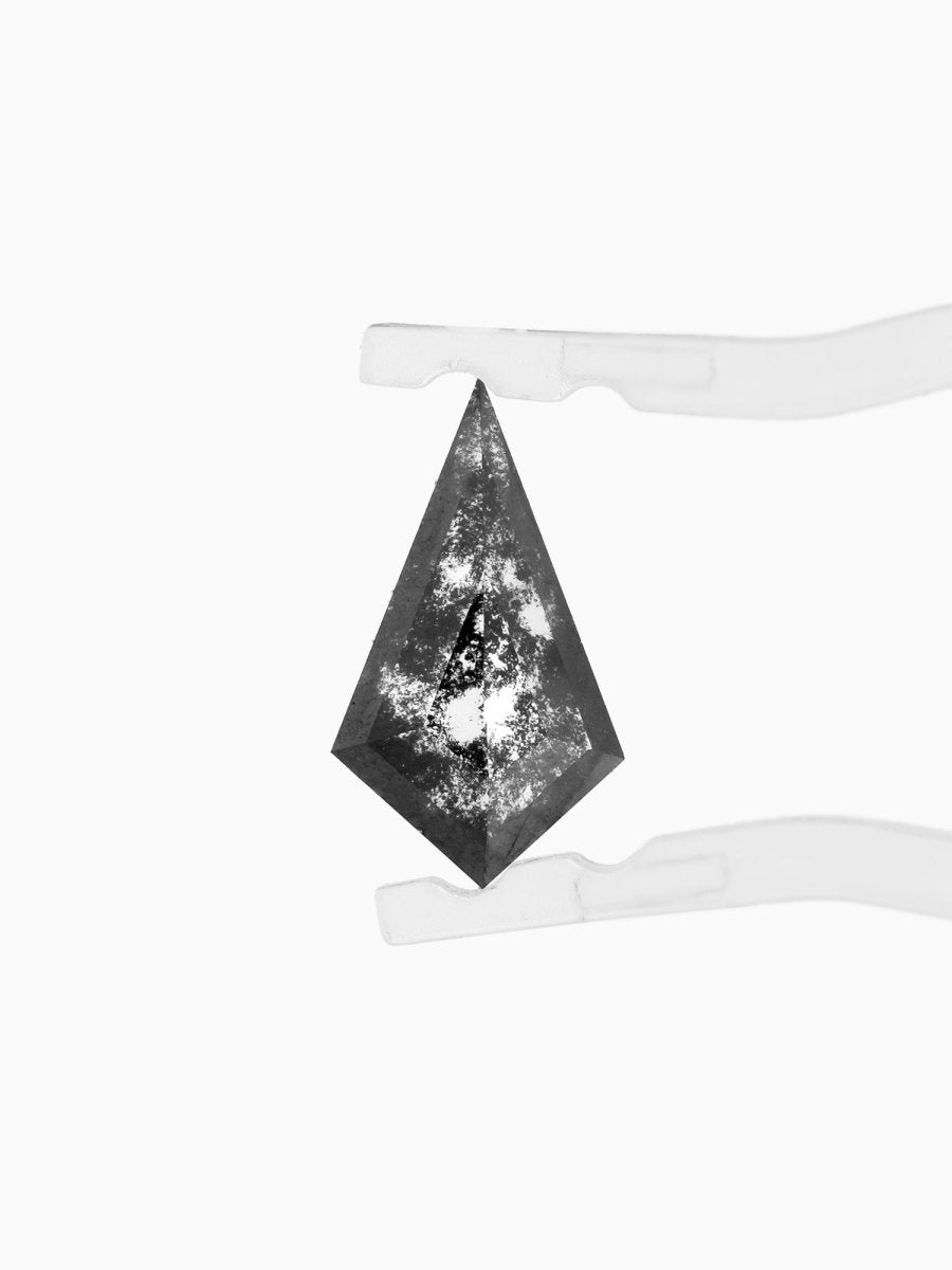 face view of loose lab-grown kite salt pepper diamond gemstone, held by tweezers