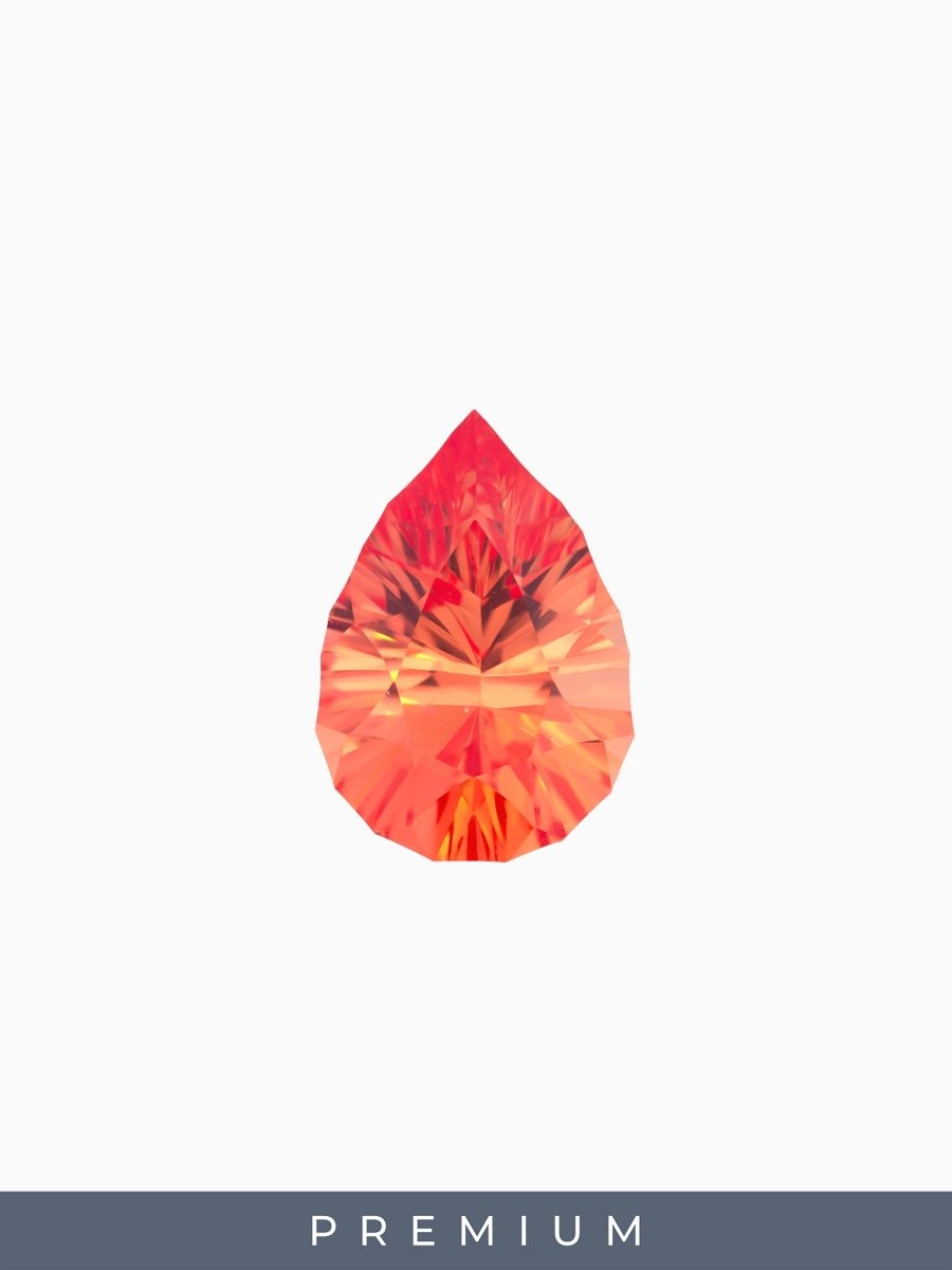 face view of designer cut orange pear sapphire on a white background with premium label
