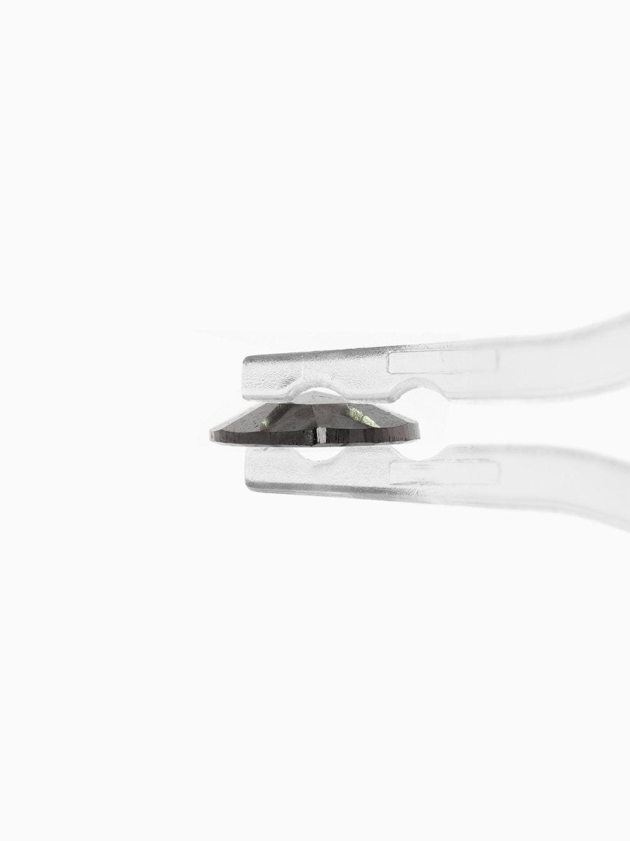 profile view of loose lab-grown pear salt pepper diamond gemstone held by tweezers