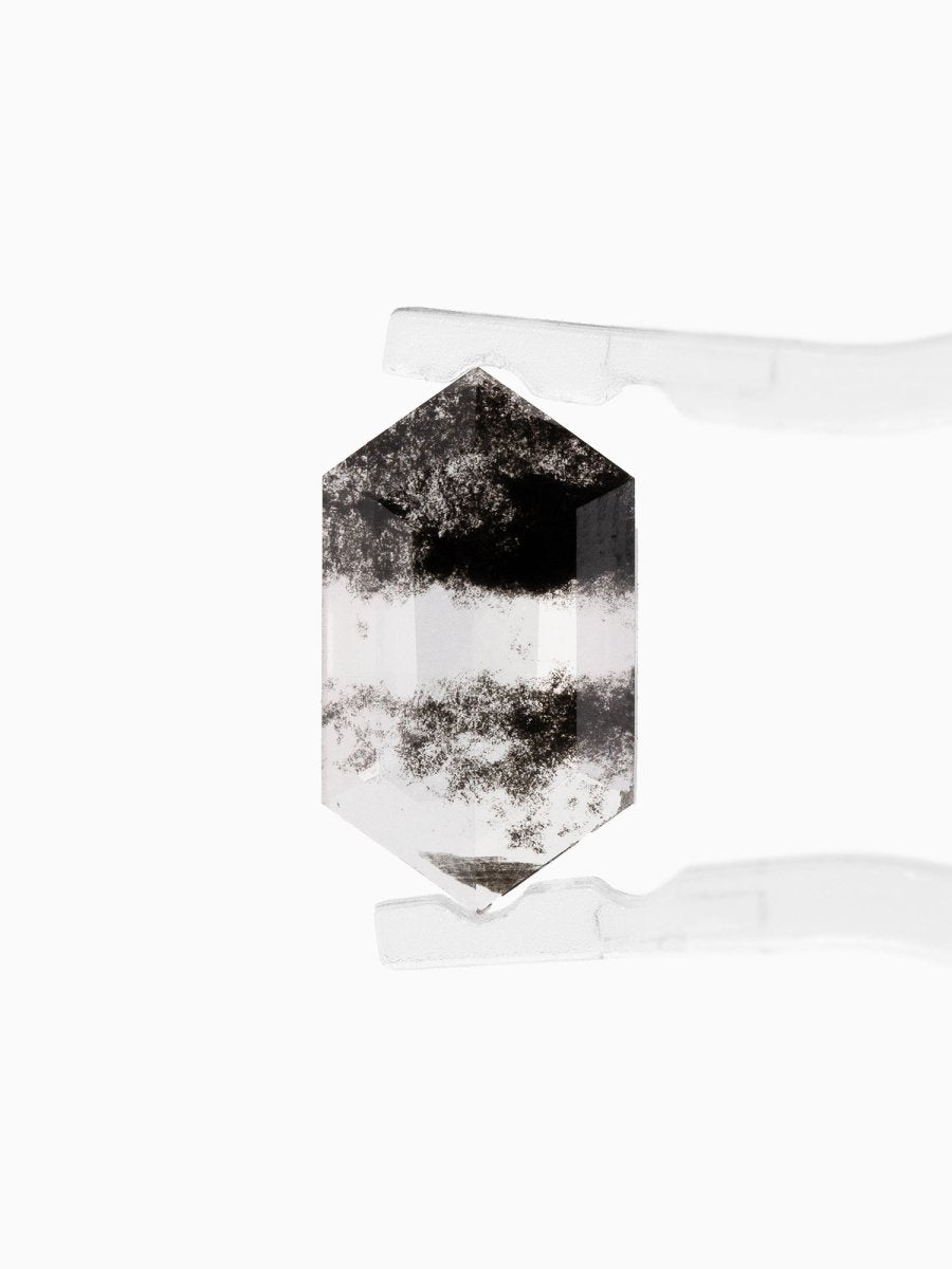 face view of loose lab-grown hexagon salt pepper diamond gemstone held by tweezers