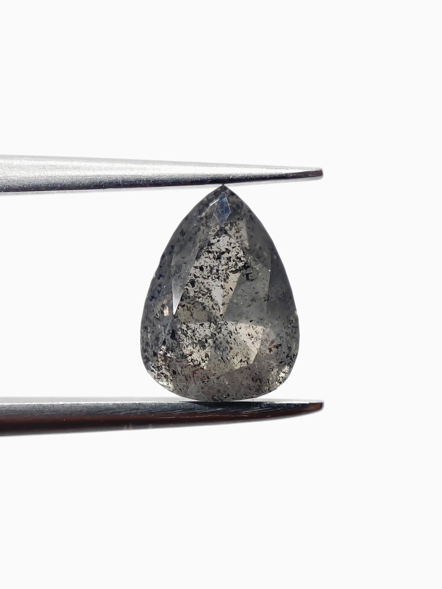 sustainable lab-grown pear shaped salt pepper diamond between tweezers