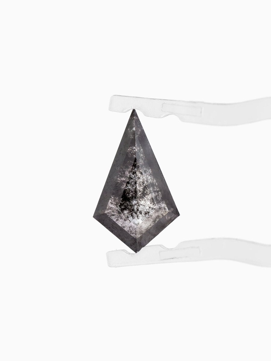 face view of loose lab-grown kite salt pepper diamond gemstone, held by tweezers