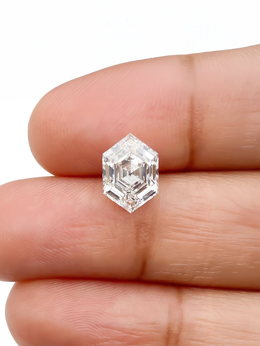hexagon lab grown white diamond on a white background on fingers for scale