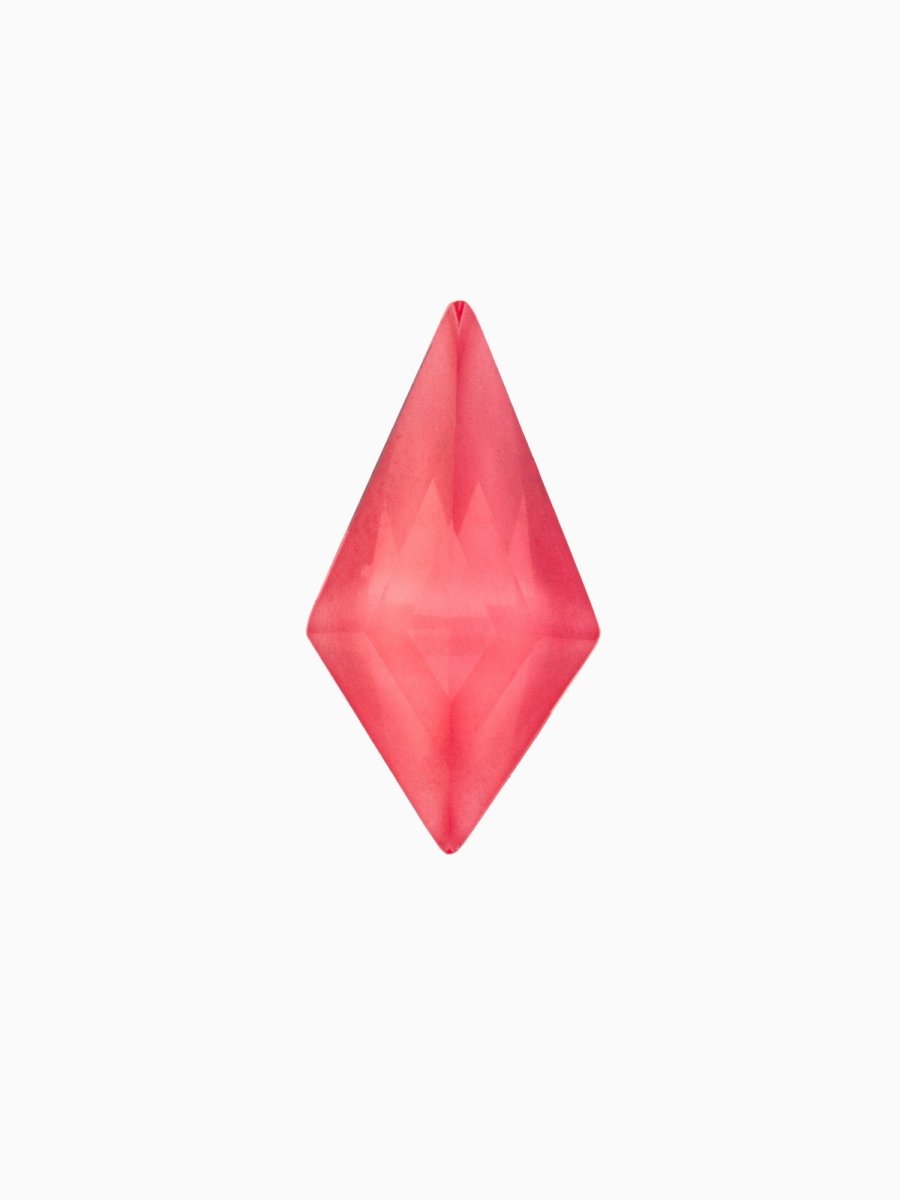 A kite-shaped, red lab-grown sapphire gemstone