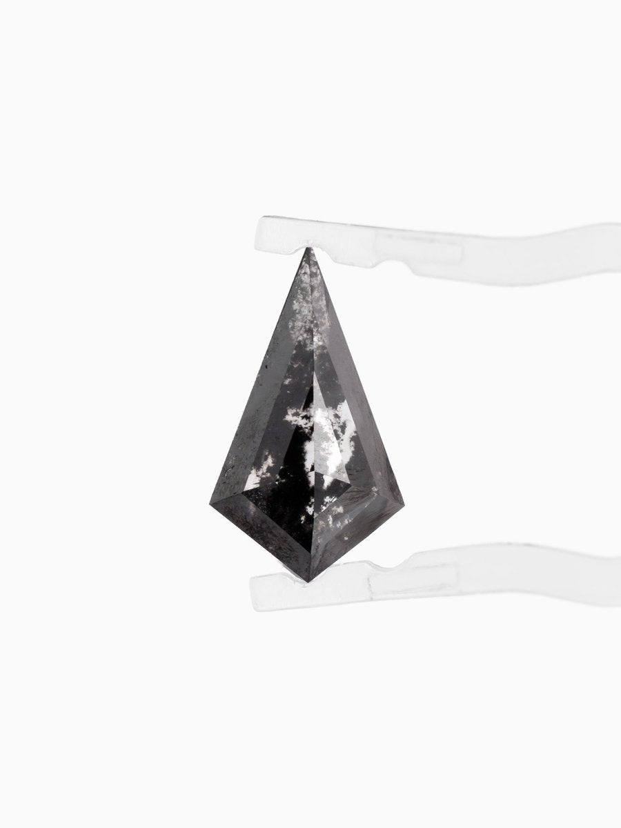 face view of loose lab-grown kite salt pepper diamond gemstone, held by tweezers