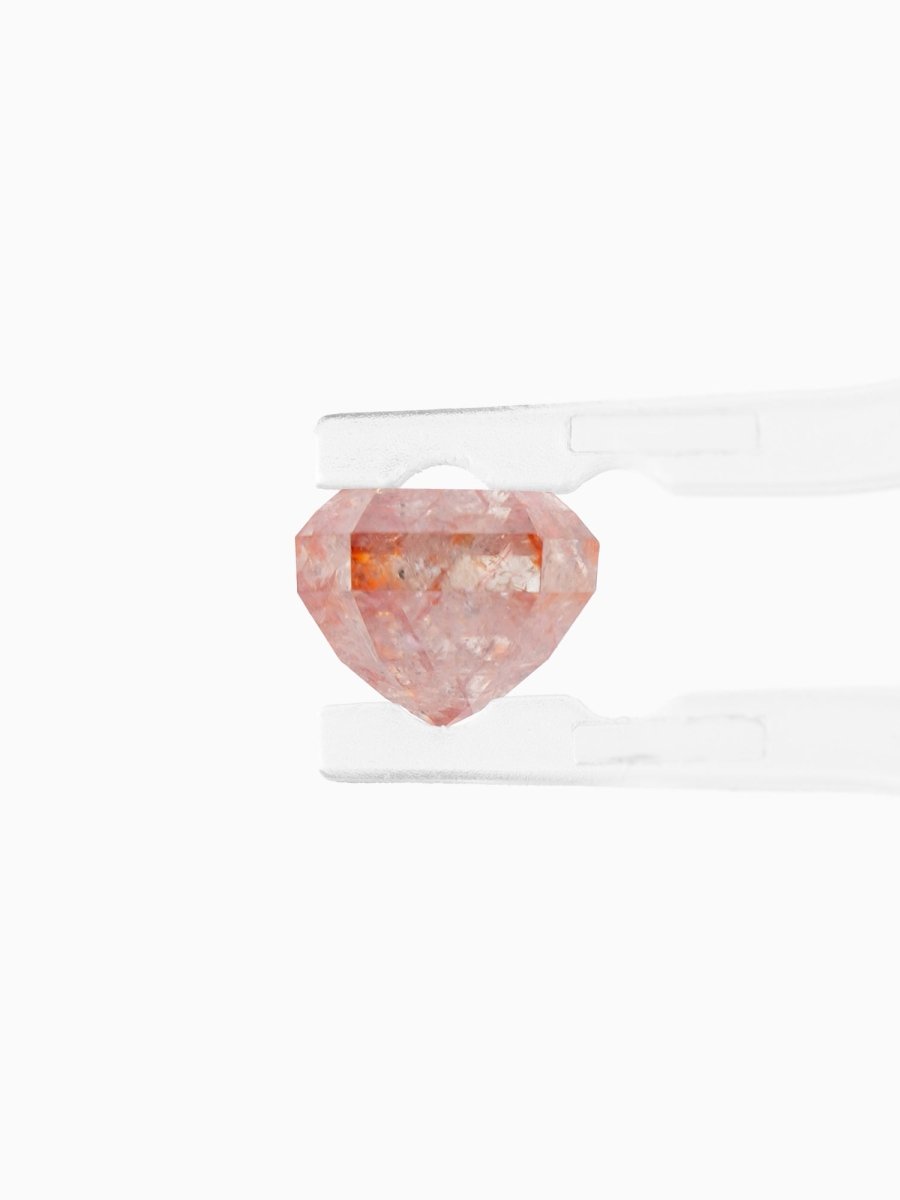 side view of loose lab-grown emerald-cut rose salt pepper diamond gemstone between tweezers