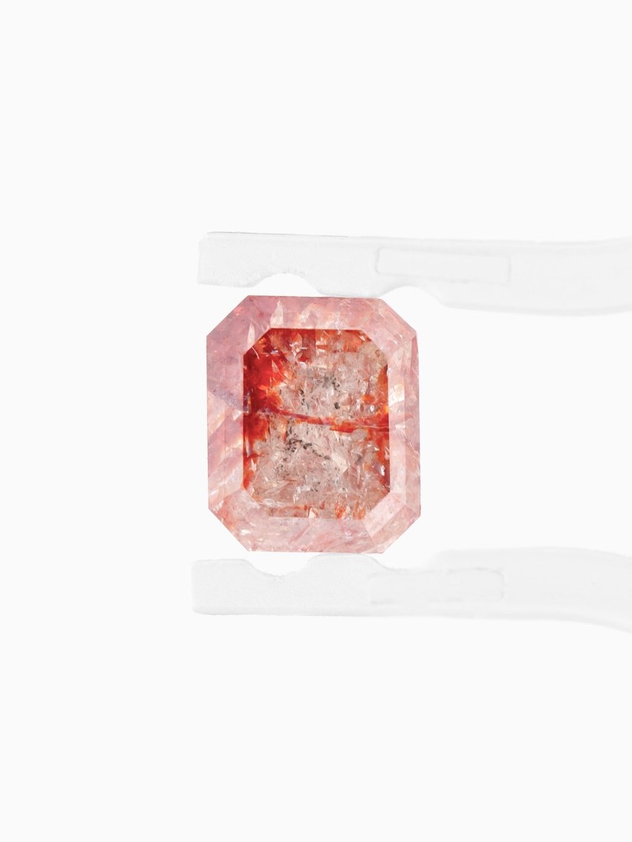 face view of loose lab-grown emerald-cut rose salt pepper diamond gemstone between tweezers