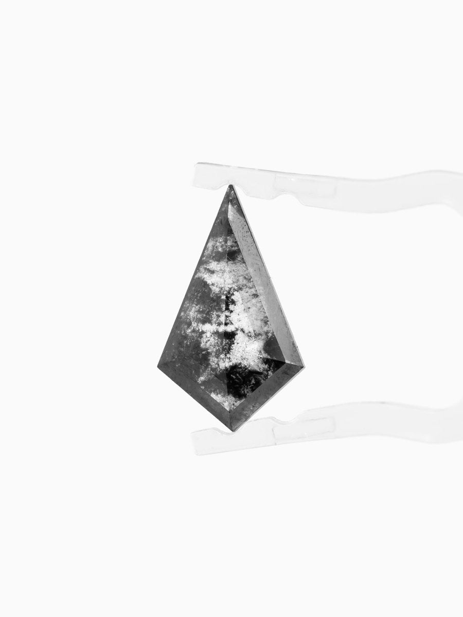 face view of loose lab-grown kite salt pepper diamond gemstone, held by tweezers