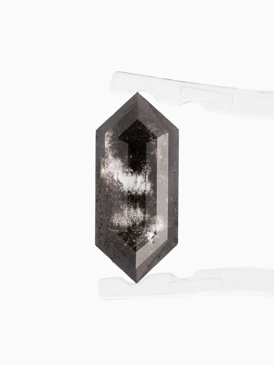 face view of loose lab-grown hexagon salt pepper diamond gemstone held by tweezers
