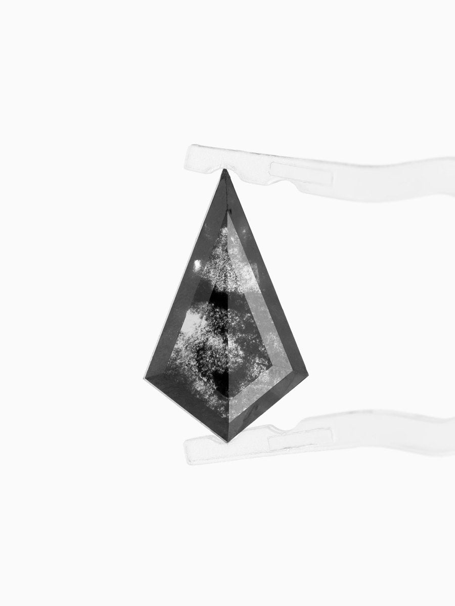 face view of loose lab-grown kite salt pepper diamond gemstone, held by tweezers