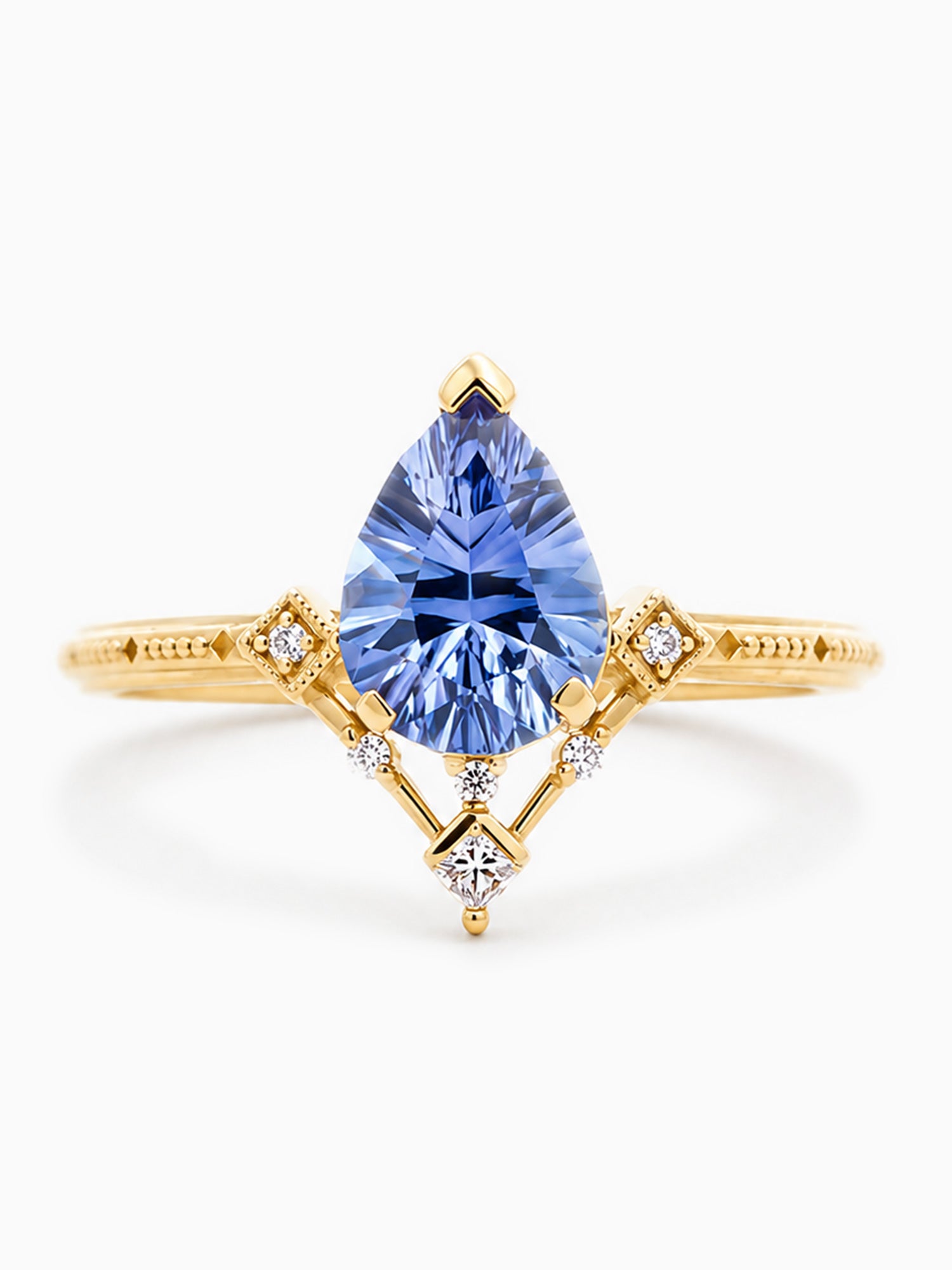 Gold ring with a blue gemstone on a white background