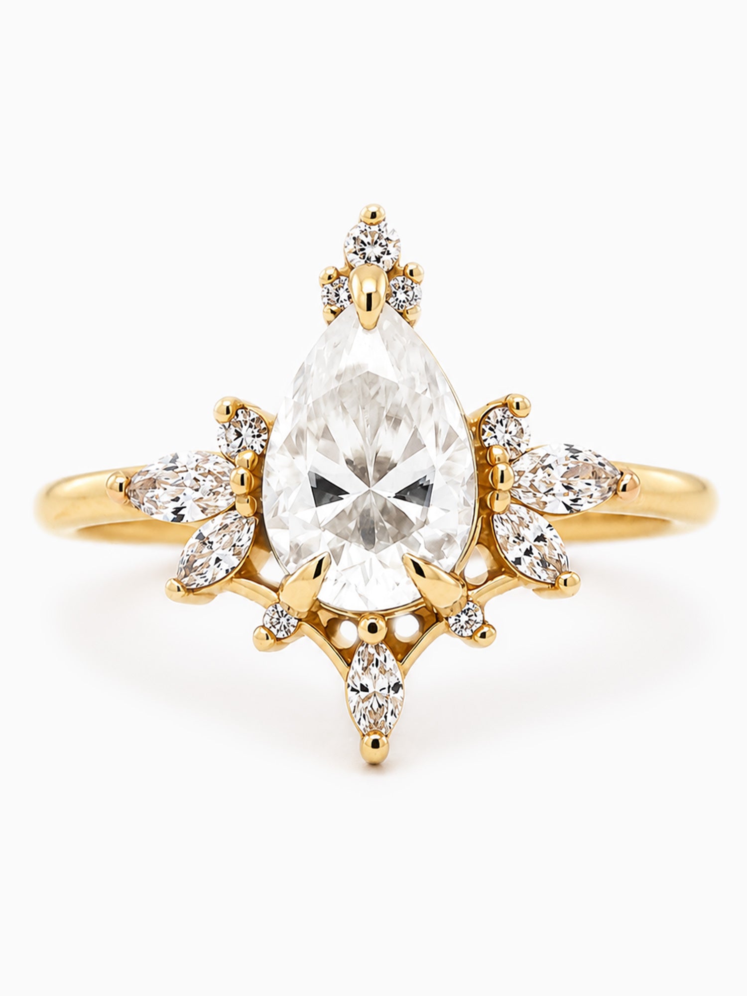 Gold ring with a large pear-shaped diamond and smaller diamonds on a white background