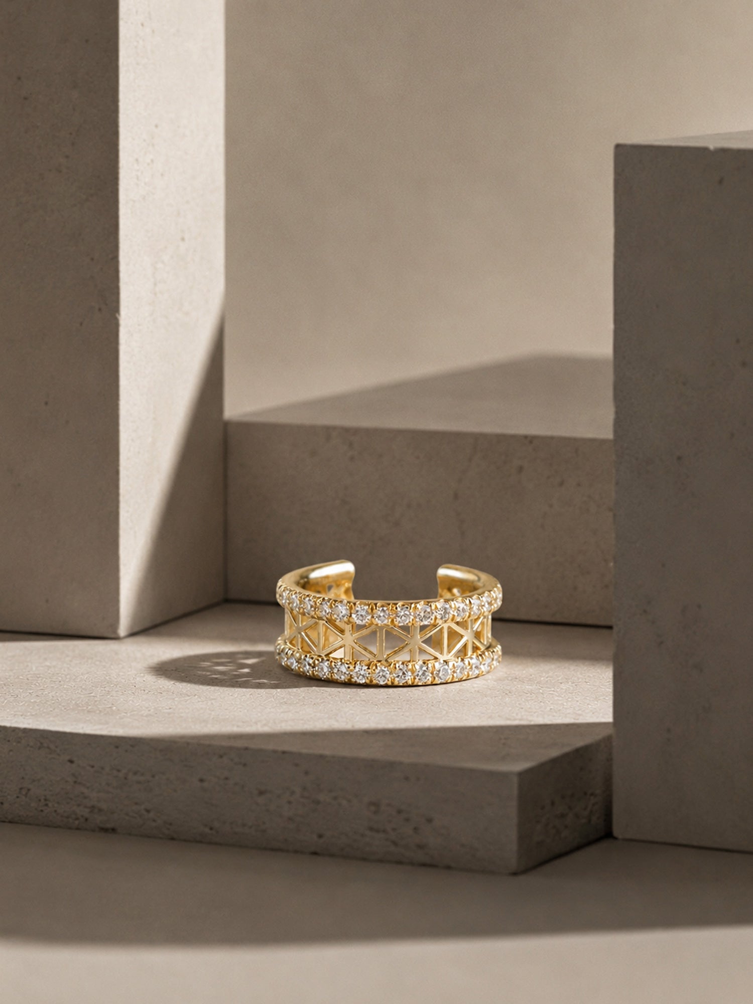 Gold ring with diamond accents on a concrete surface