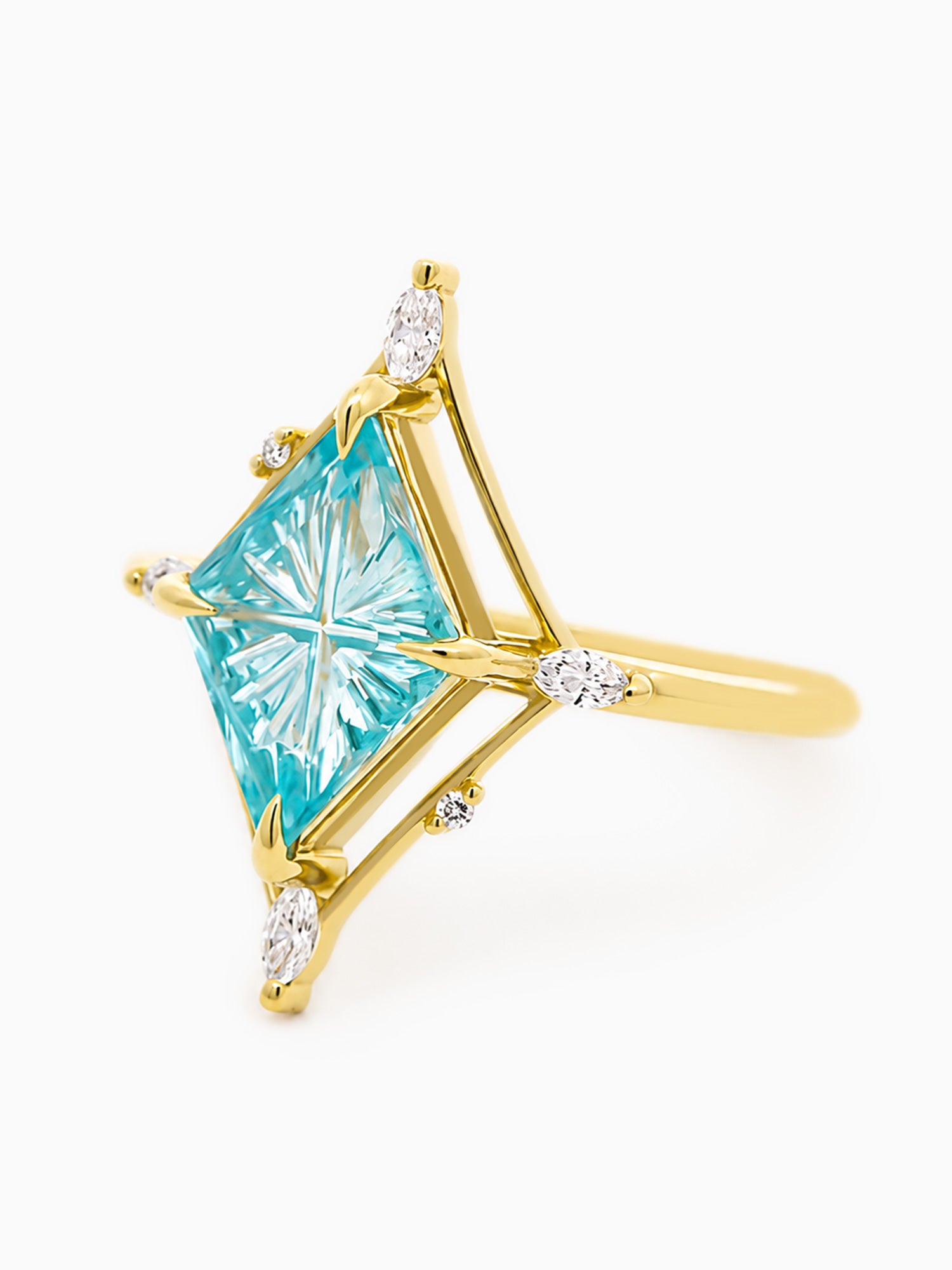 Gold ring with a large blue gemstone and smaller diamonds on a white background