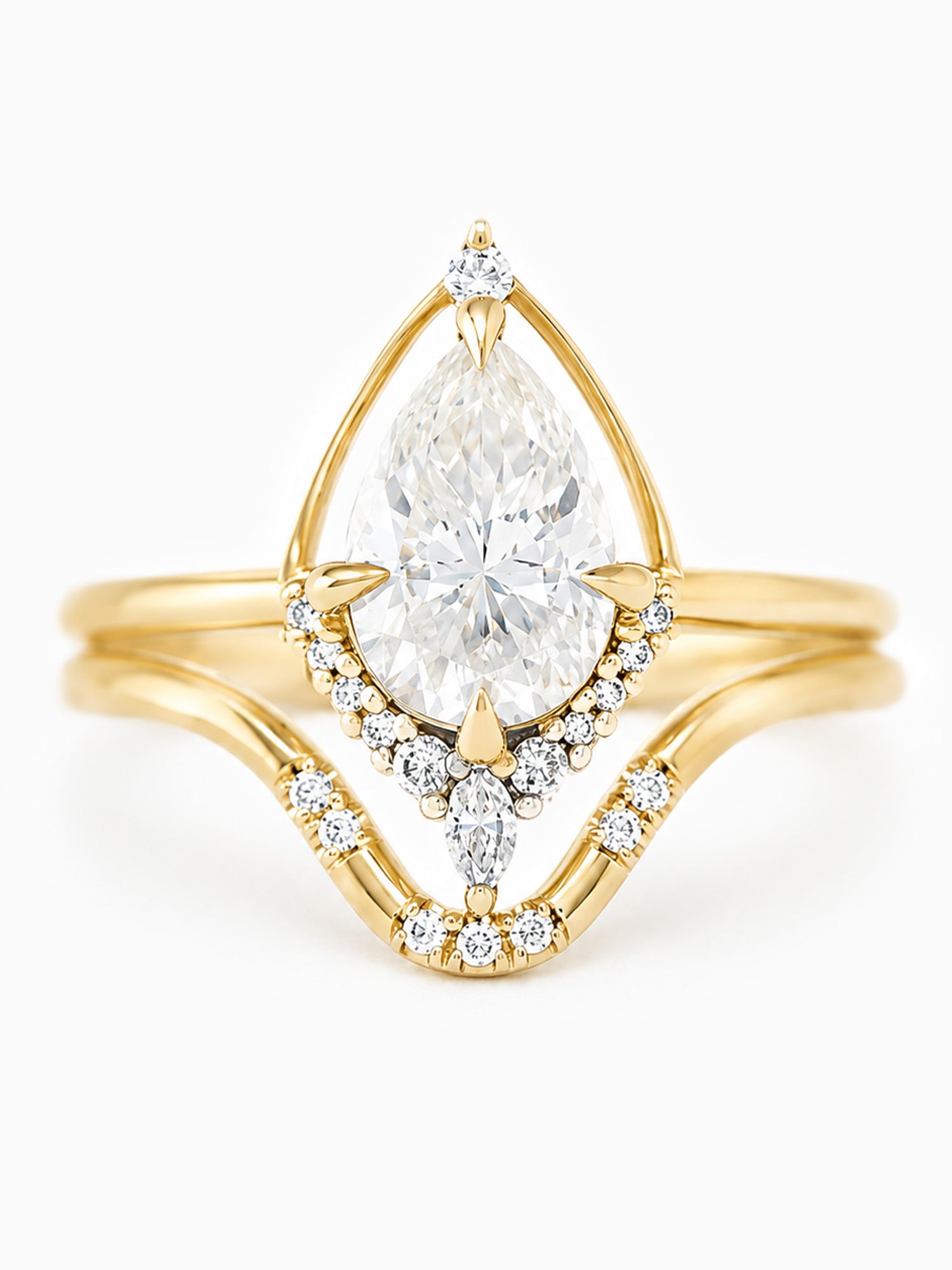 Gold ring with a pear-shaped diamond on a white background