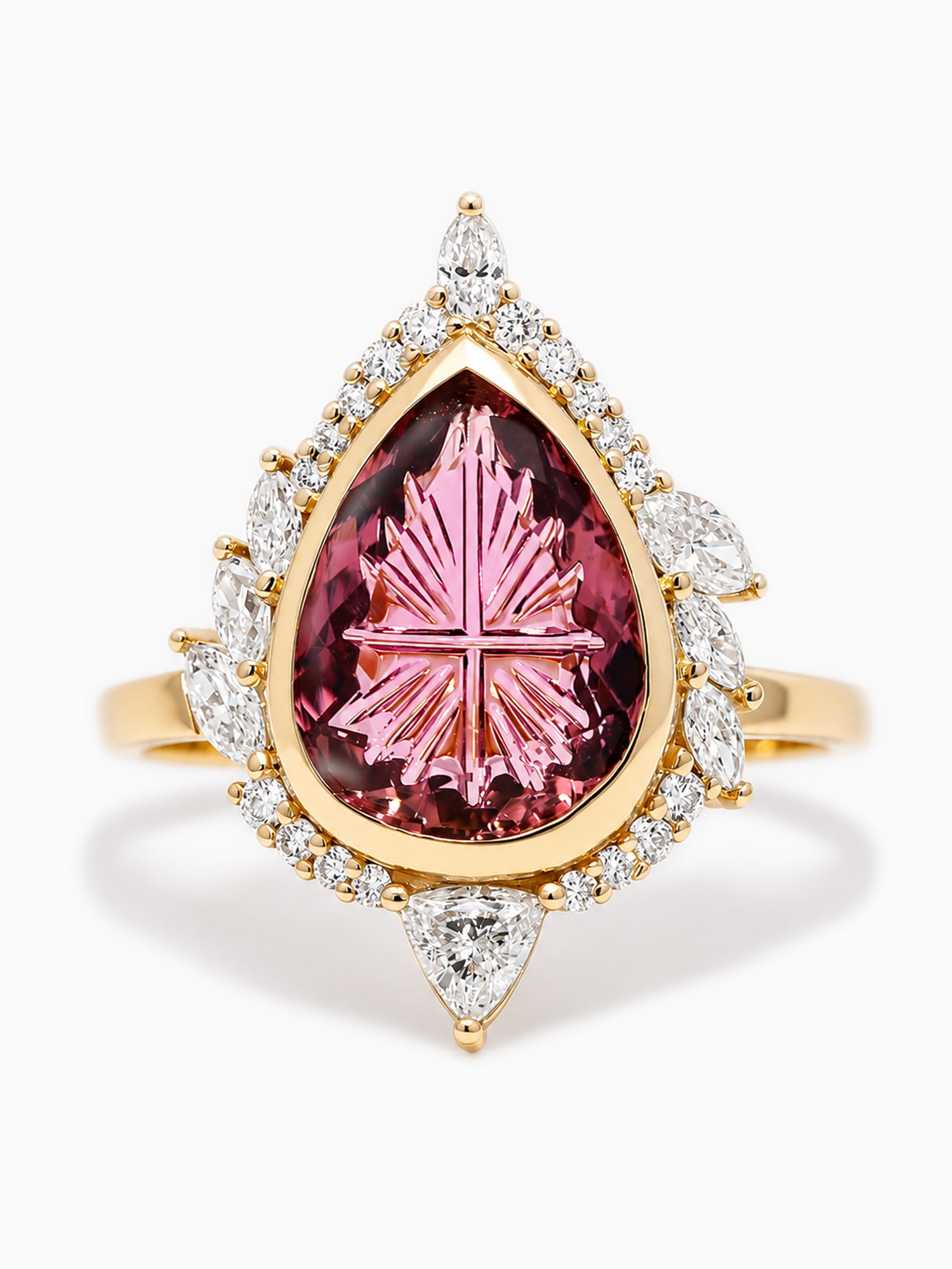 Gold ring with a pink gemstone and diamond accents on a white background