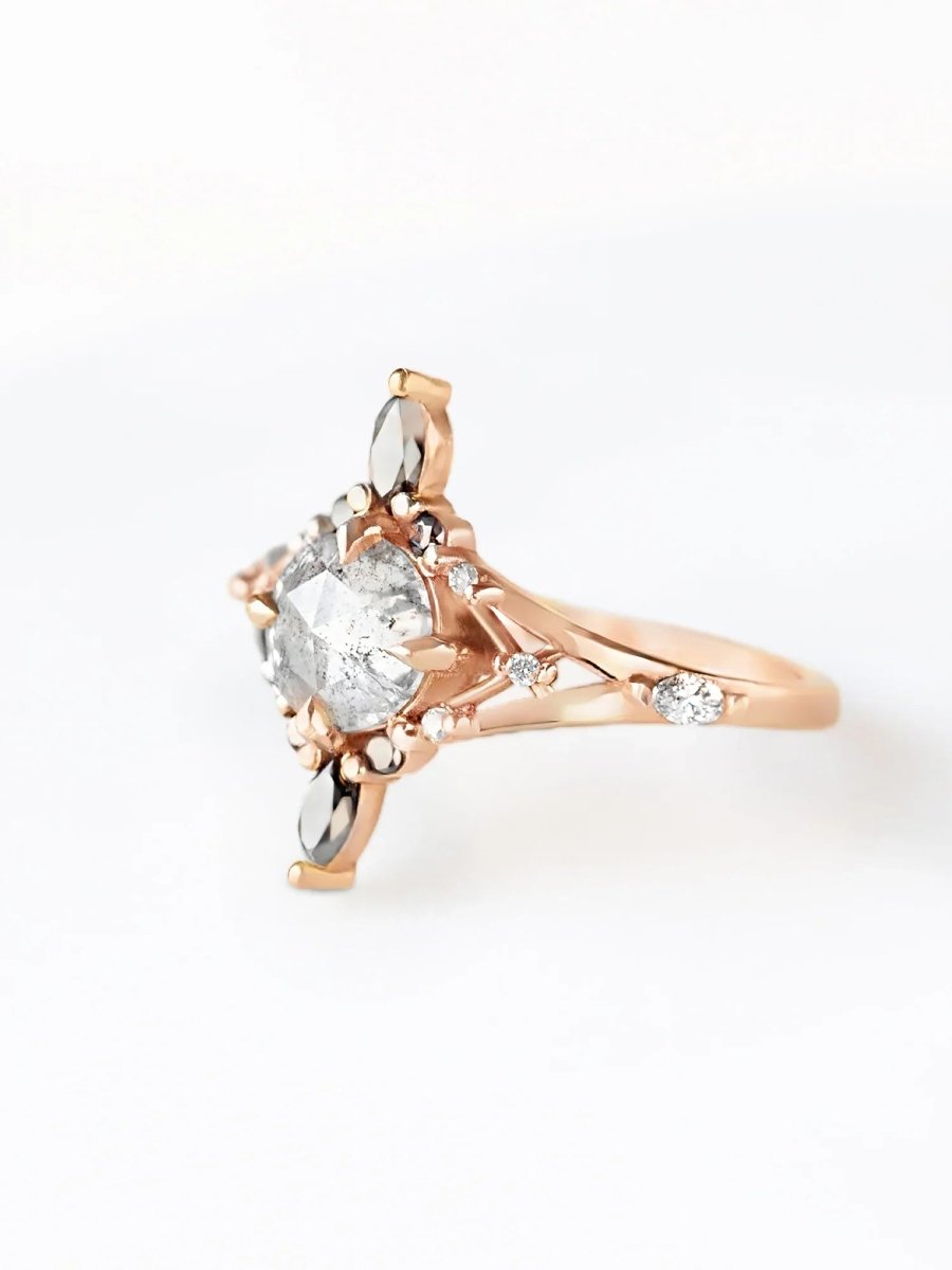 Rose gold ring with a round-shaped diamond on a white background