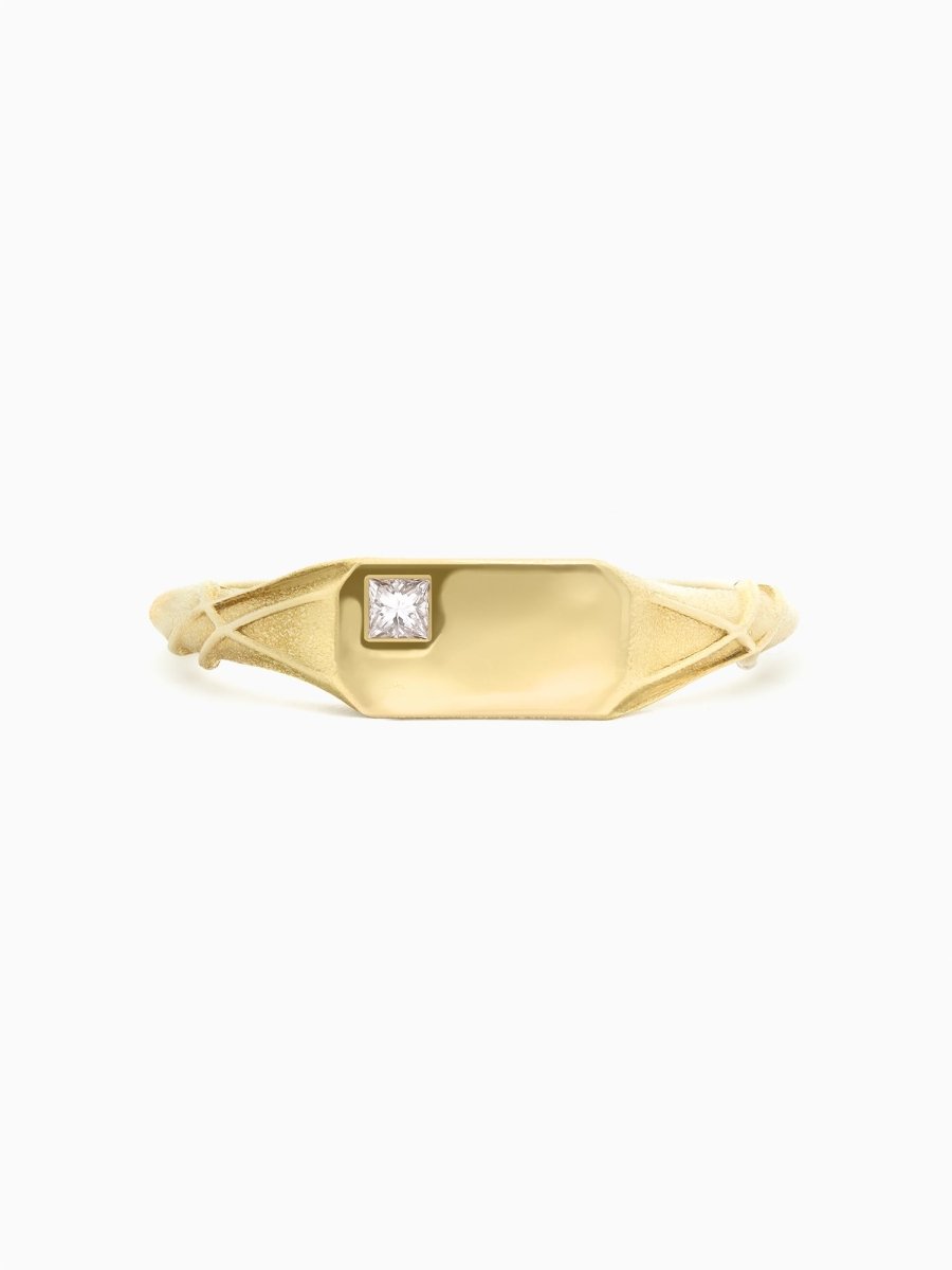 Face view of gold ring with twisting organic shoulders and polished rectangular face featuring an off-center square diamond.