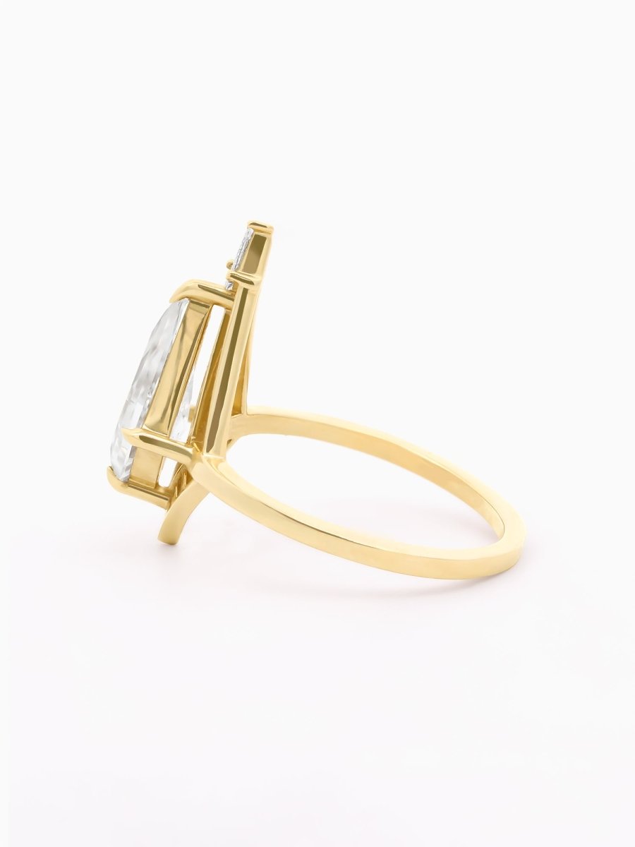 Side view of Atria Ring with elevated Moissanite above airy gold setting and slender column base