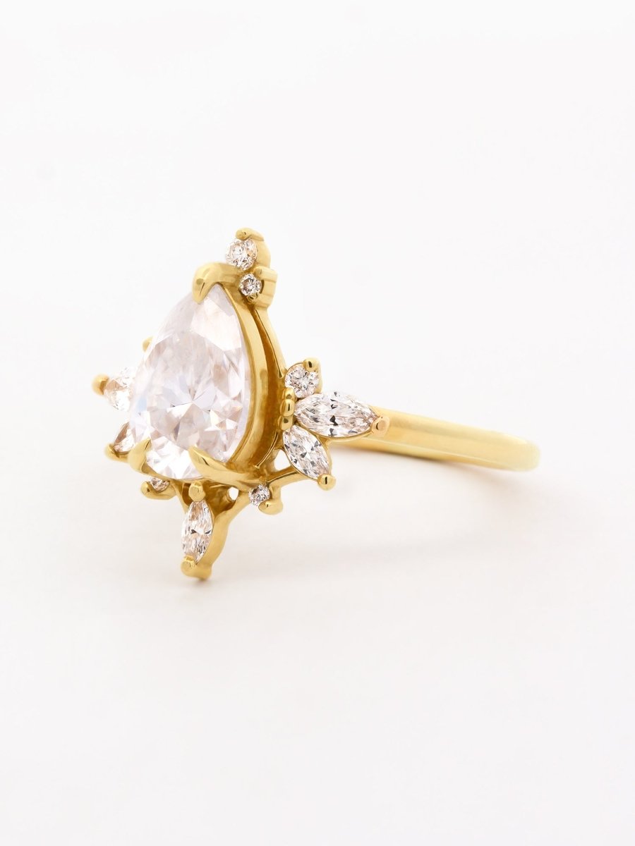 side of vintage-modern Art Deco ring with floating pear diamond in sunburst halo of assorted stones