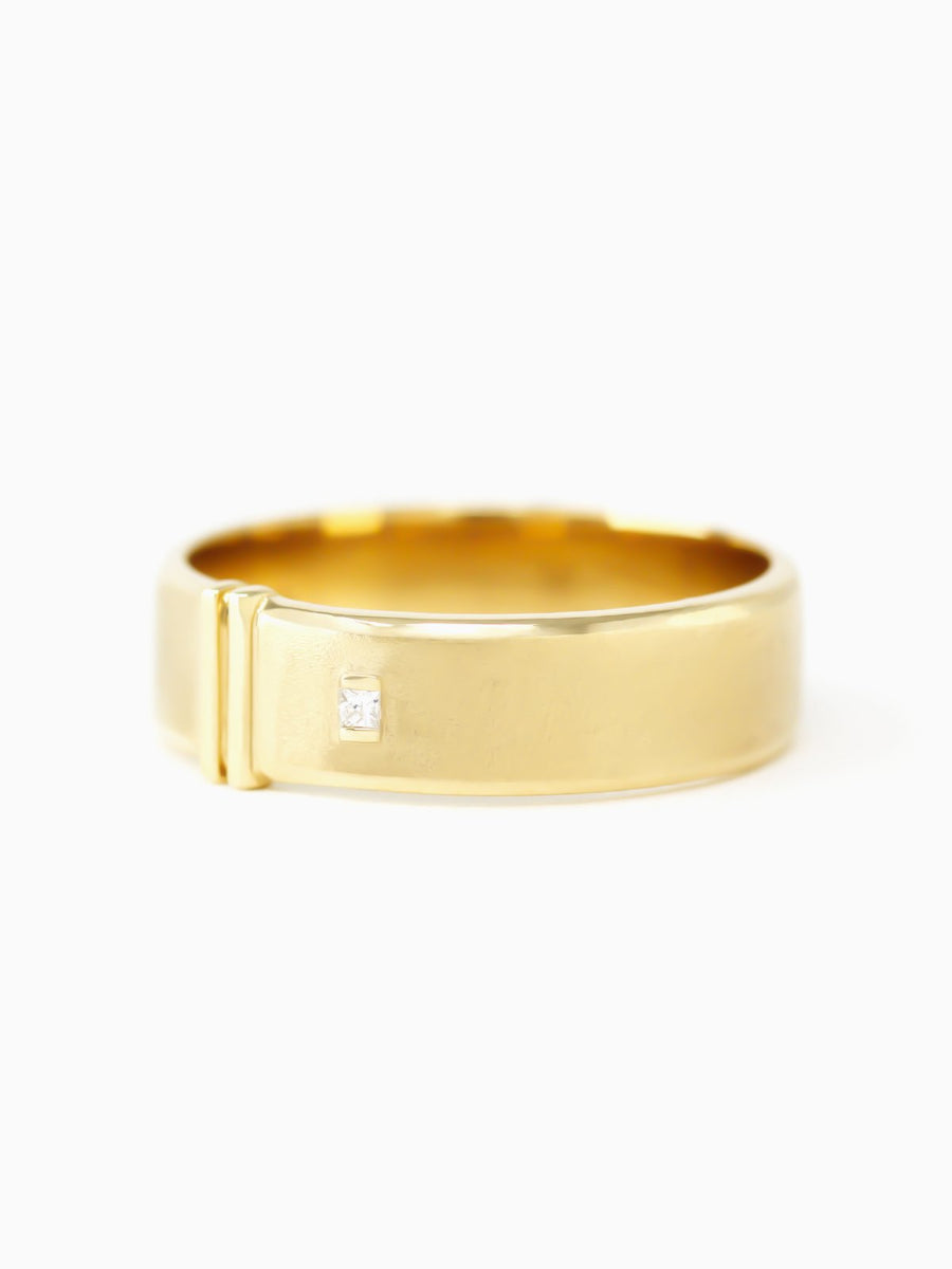 Gold ring with a small diamond on a white background