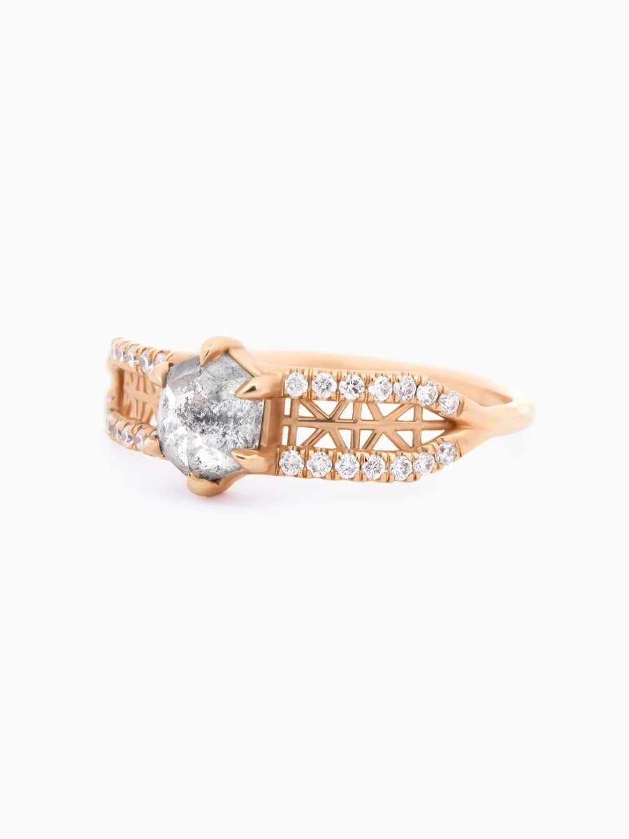 3/4 view of contemporary architectural engagement ring with split shank, lattice detail, pave melee diamonds, and claw-pronged hexagon salt pepper diamond