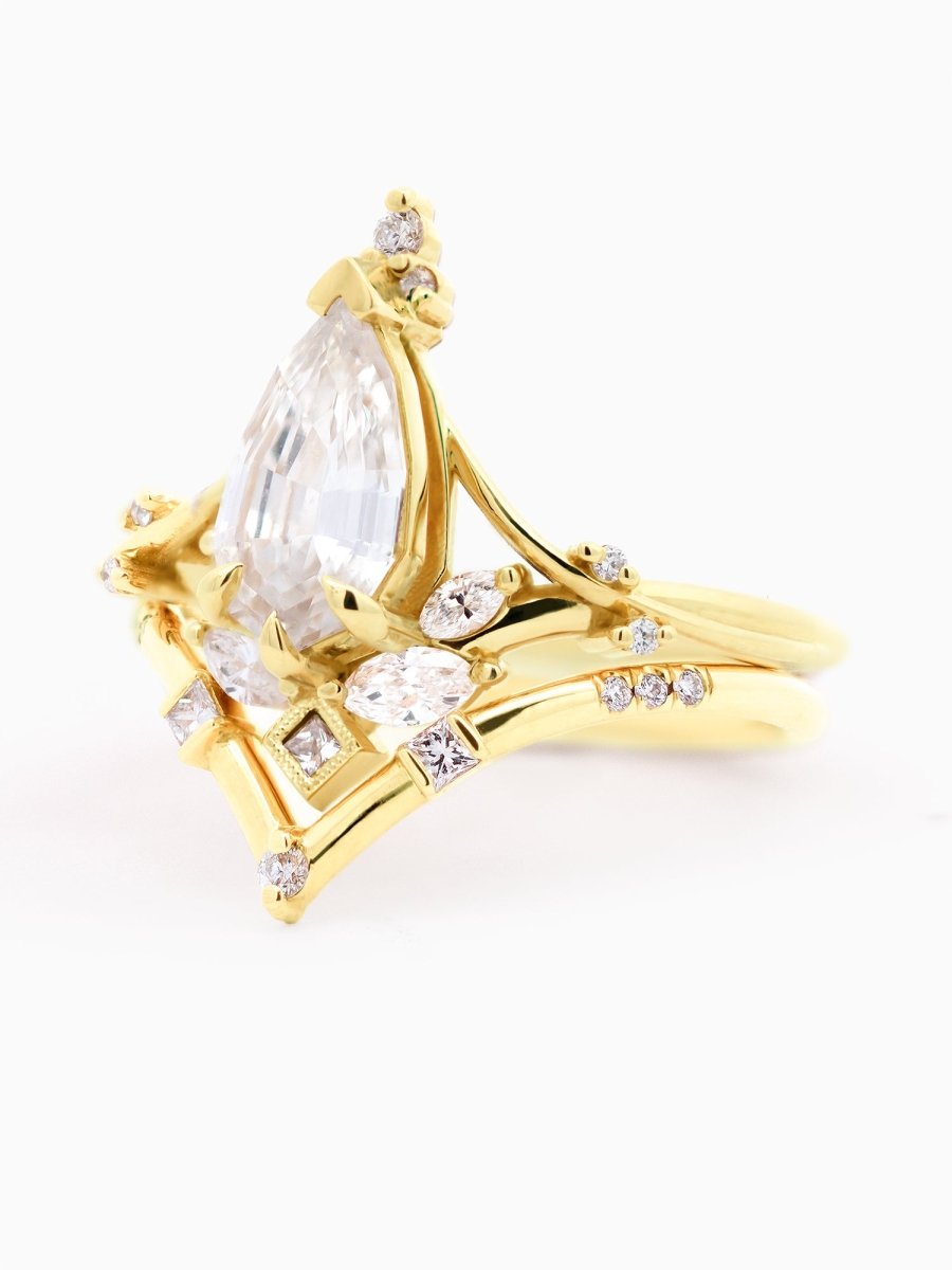 side of Art Nouveau engagement ring with marquise diamond, split shank, milgrain accents, and chevron contour band