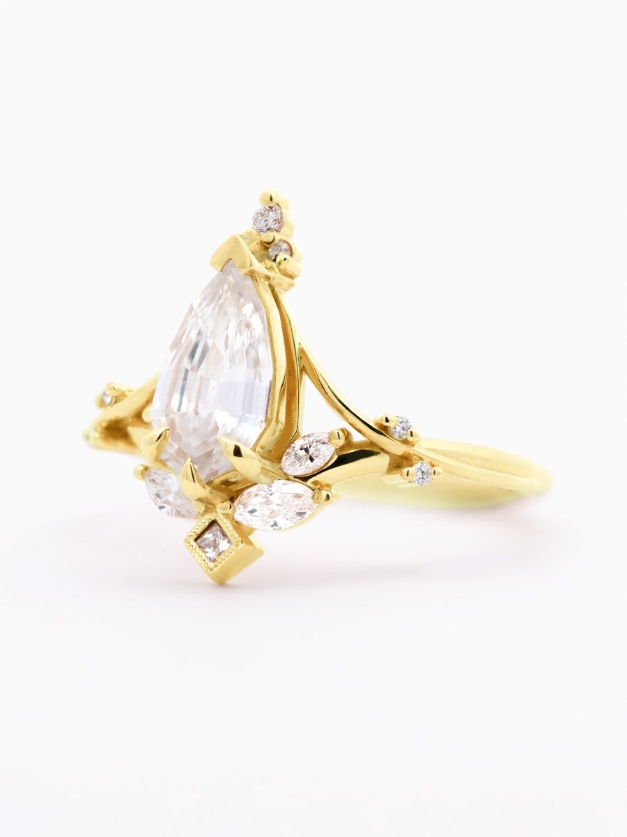 left of Art Nouveau engagement ring with marquise diamond, split shank, milgrain accents, and chevron band