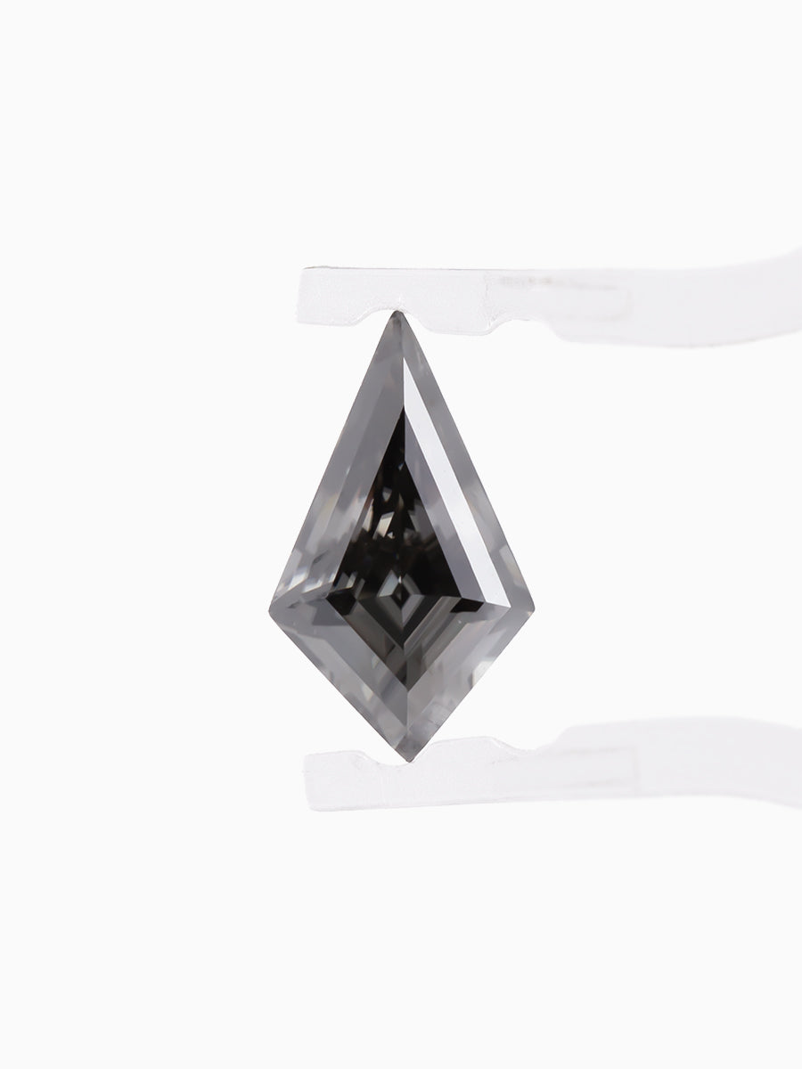 Black kite shaped moissanite held by tweezers, face view