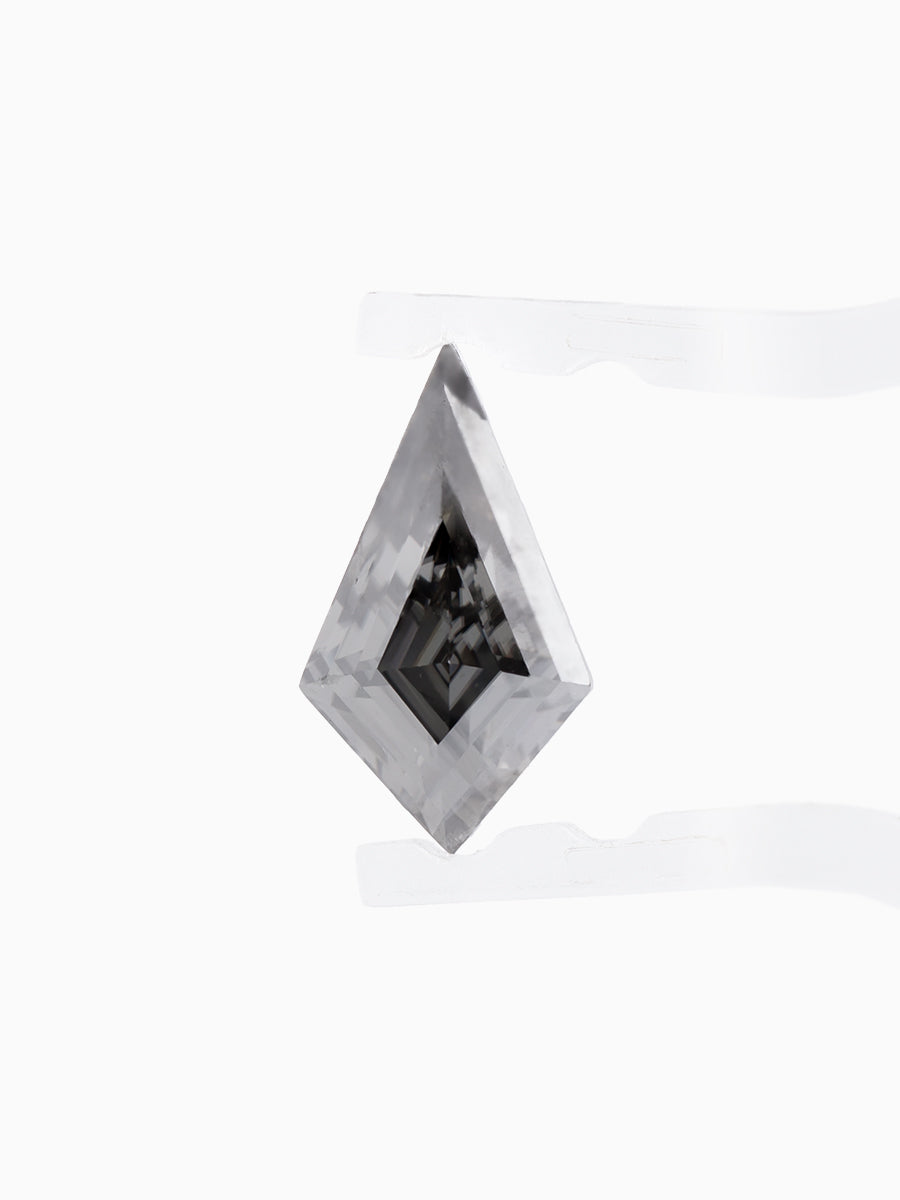 Black kite shaped moissanite held by tweezers, face view