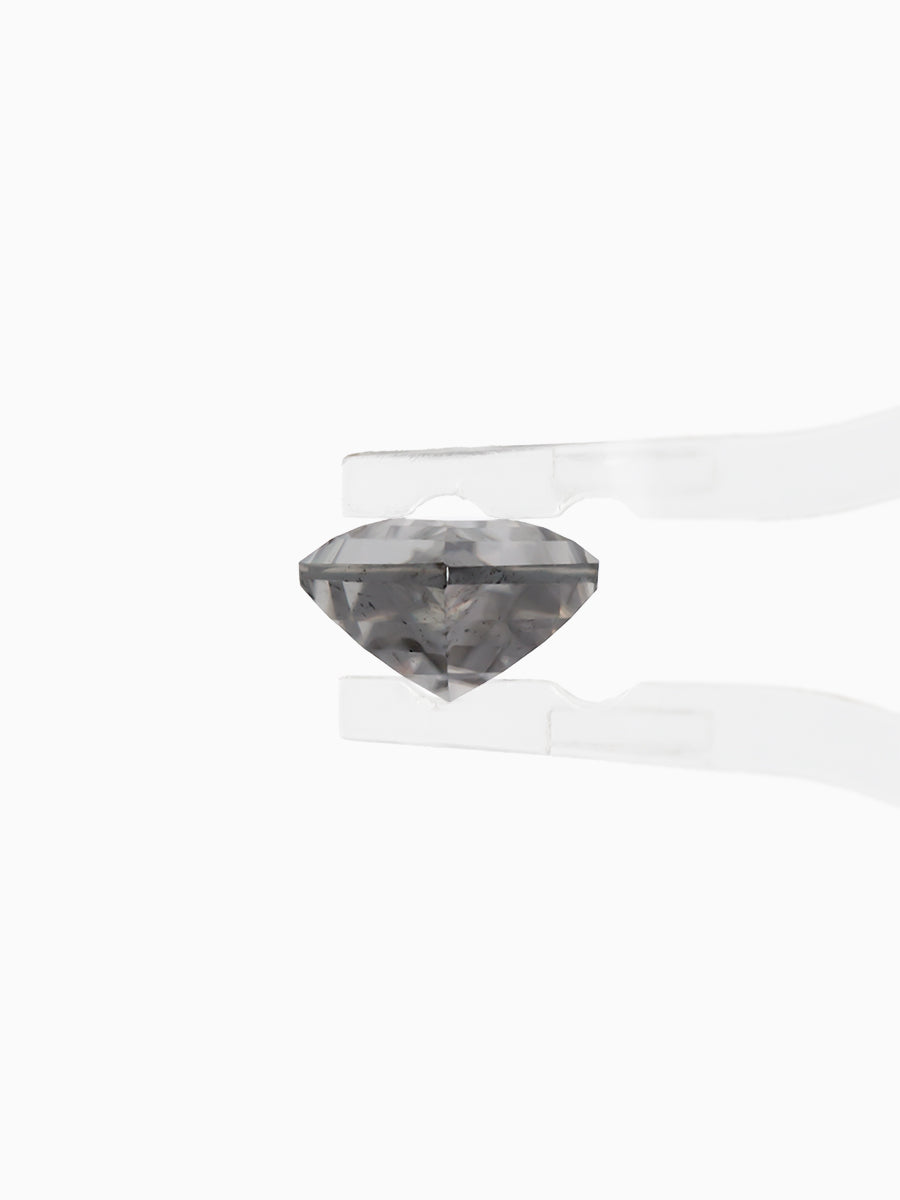 Black kite shaped moissanite held by tweezers, side view