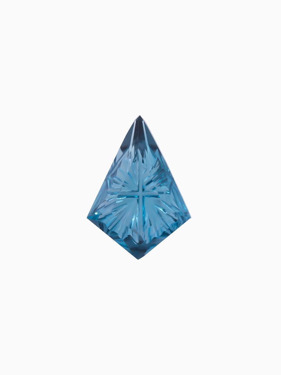lab grown fantasy cut deep blue topaz kite with radiating facets on white background