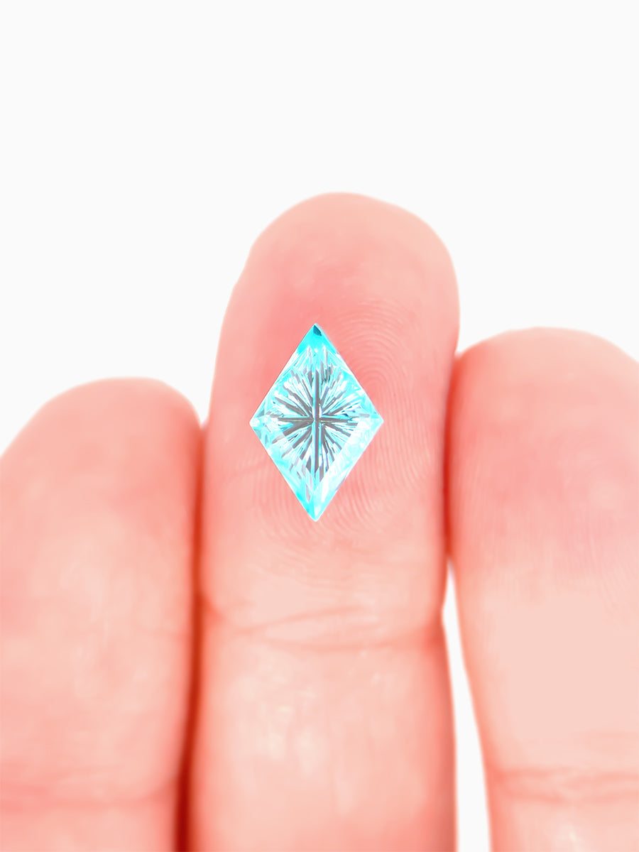 lab grown fantasy cut teal sapphire kite on finger to show scale