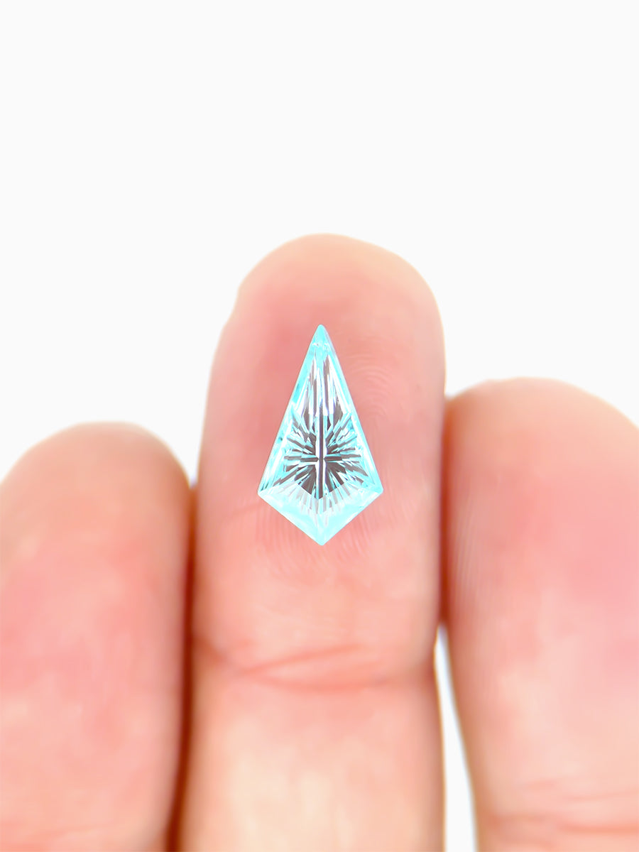 lab grown fantasy cut teal sapphire kite on finger to show scale