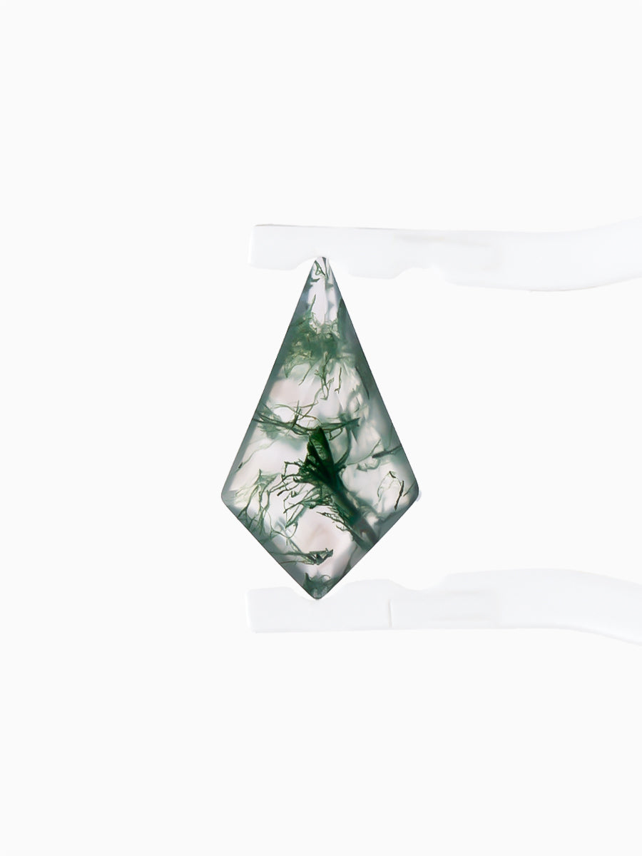 Kite-shaped loose moss agate gemstone with dendritic green inclusions held by tweezers, face view