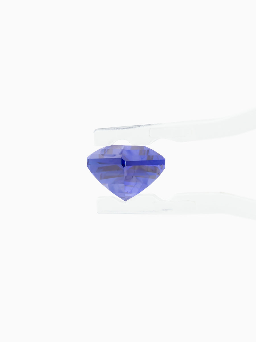 deep royal blue sapphire kite held by tweezers, side view