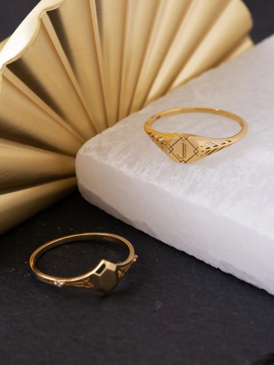 Gold rings on a textured surface with a decorative gold background