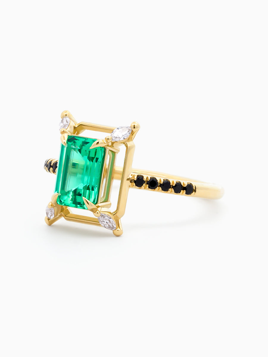 Three-quarter view of Verdant Ring showing floating emerald setting and black onyx pavé gallery on white background