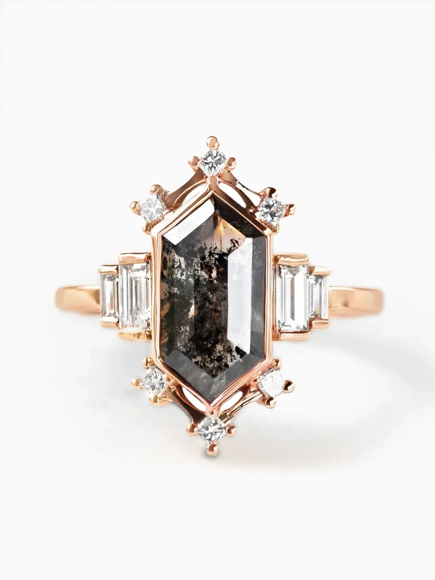 Rose gold ring with a large central gemstone and smaller diamonds on a white background