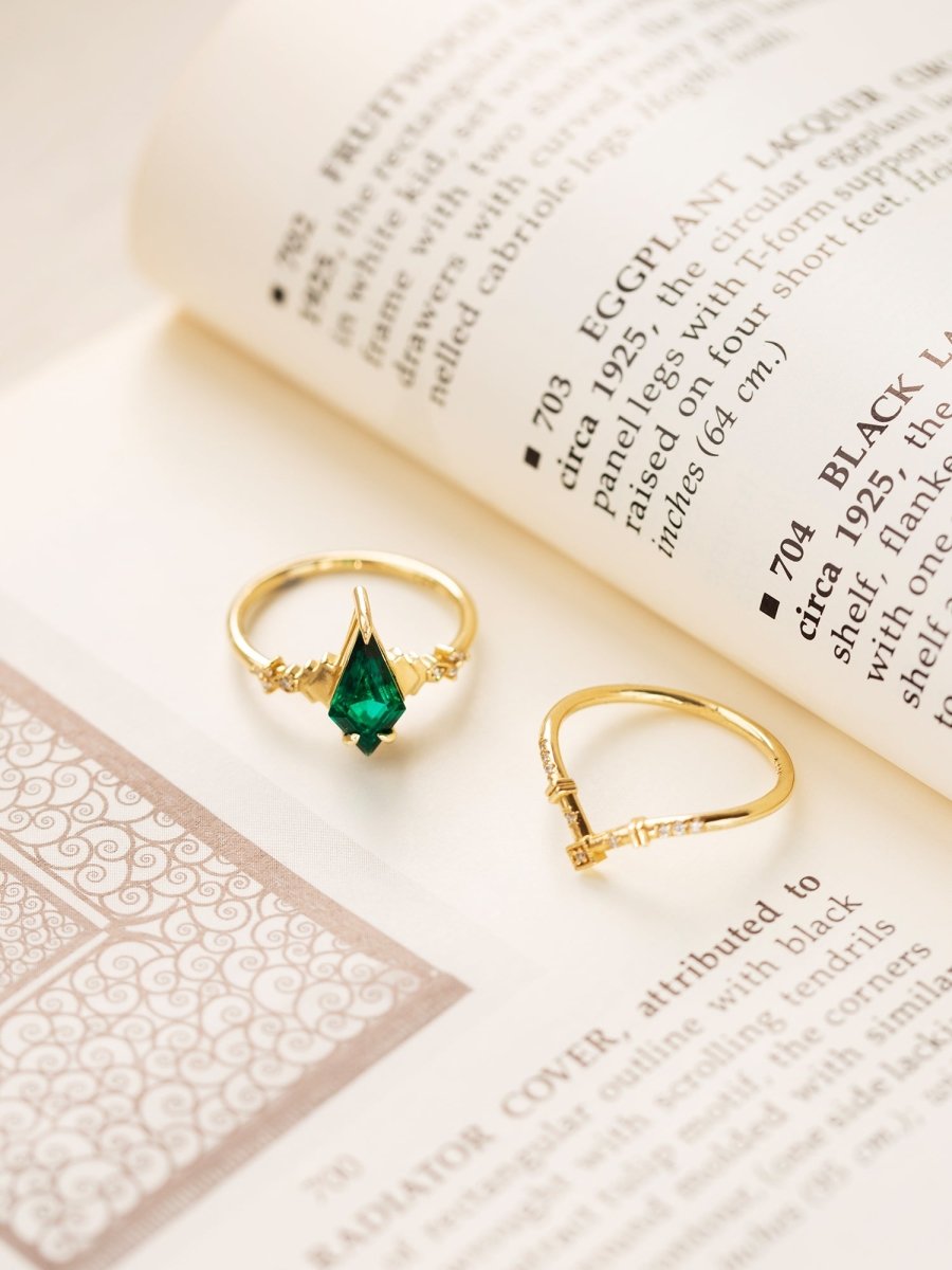 Two gold rings with gemstones on an open book