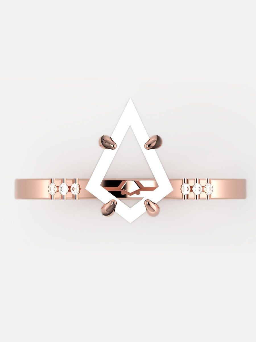 Rose gold bracelet with geometric design on a light gray background