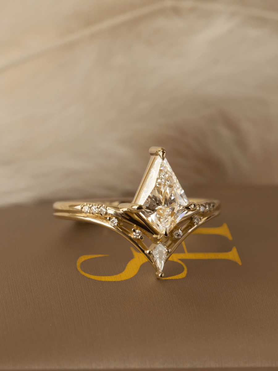 Gold ring with a diamond on a beige fabric background