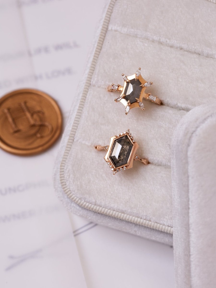 Rose gold rings with gemstones on a textured surface