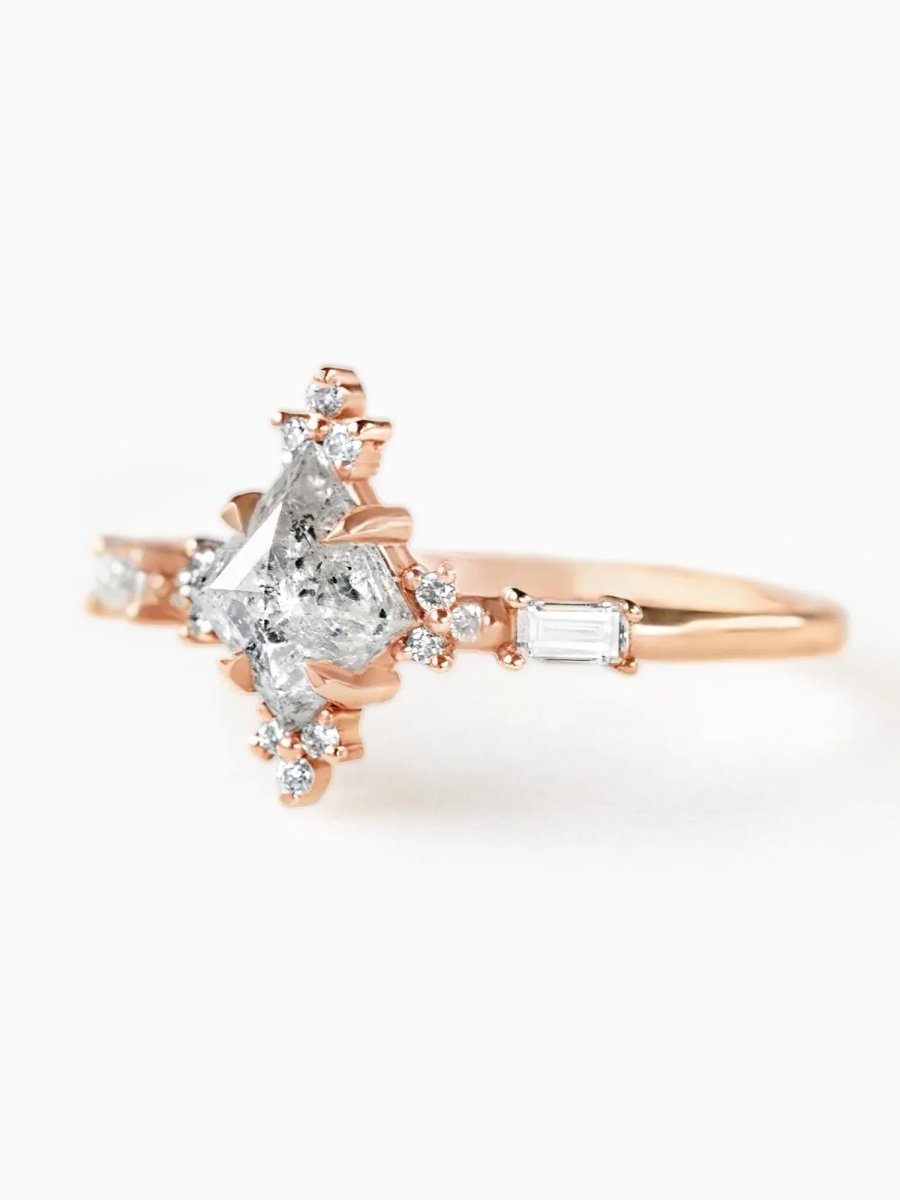 Rose gold ring with a diamond on a white background