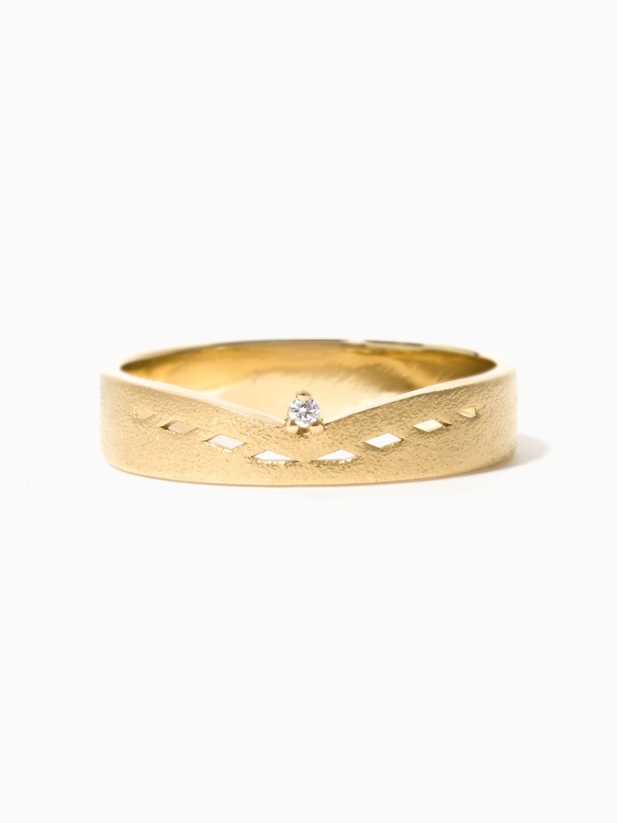 Face view of matte gold chevron ring with open rectangular cutouts and a round diamond centered in the V.