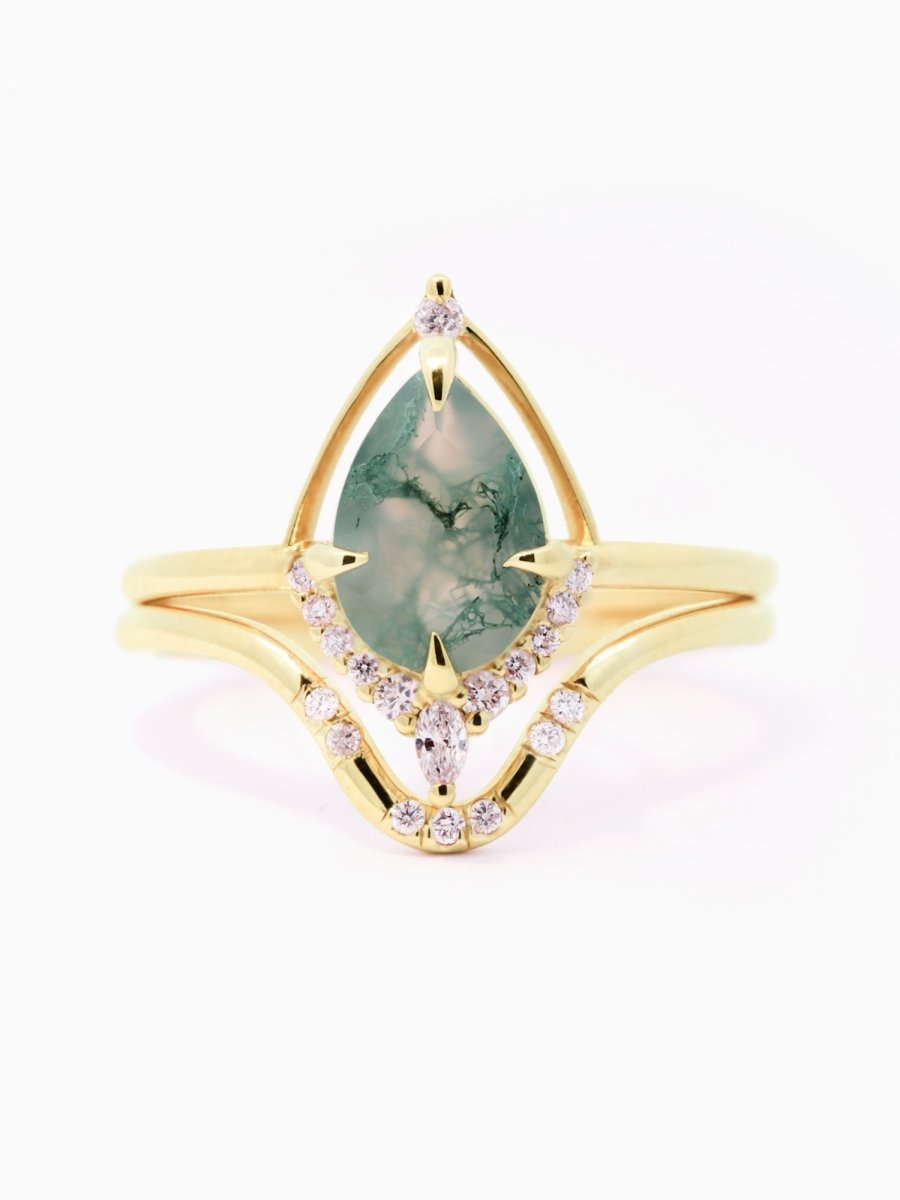 Gold ring with a green gemstone and small diamonds on a white background