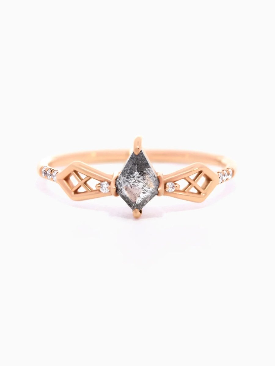 Face of modern Art Deco kite engagement ring with geometric latticed shoulders shaped like a bow and round melee diamonds on a minimalist band