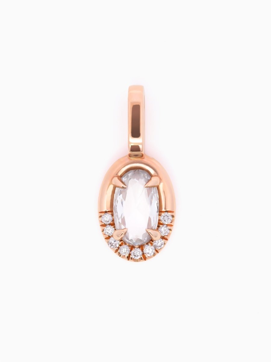Rose gold pendant with a clear gemstone on a white background